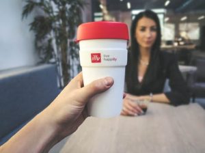 Influencer holding a cup with brand name advertised